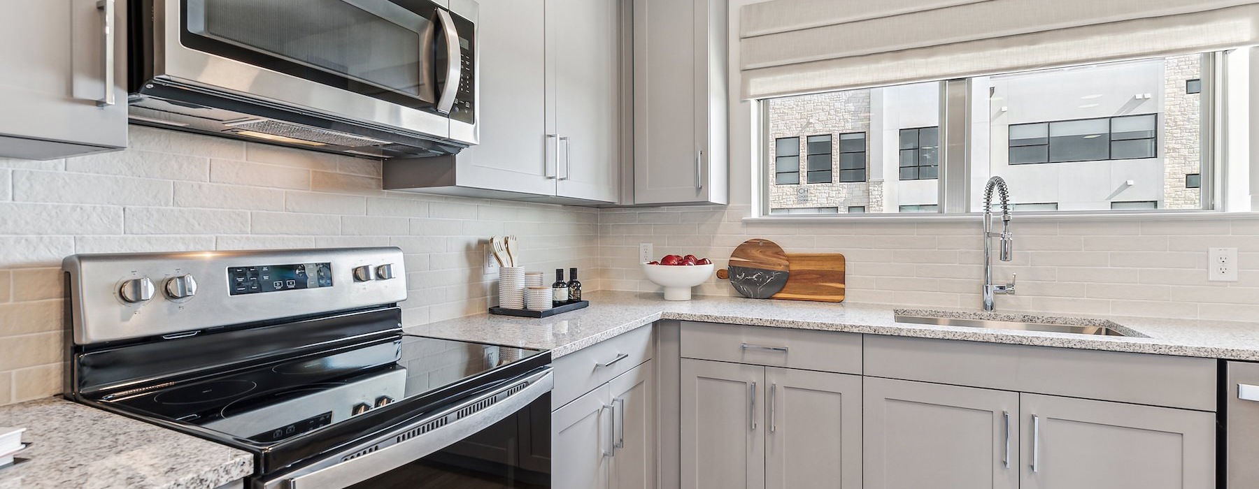 a kitchen with grey cabinets