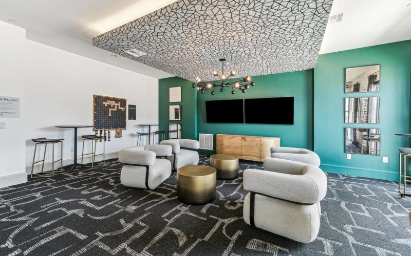 a clubhouse room with a couch and chairs